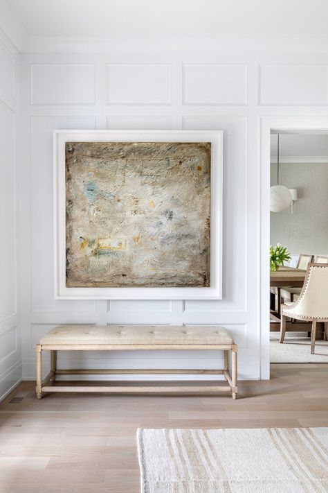 Neutral inspired entryway featuring white paneled walls, a large, square wall art and a long bench below with a cushion. New England Farmhouse, Bleached Wood, Custom Furniture Design, Eclectic Modern, Entry Way Design, Countryside House, Interior Design Art, Traditional House, Large Wall