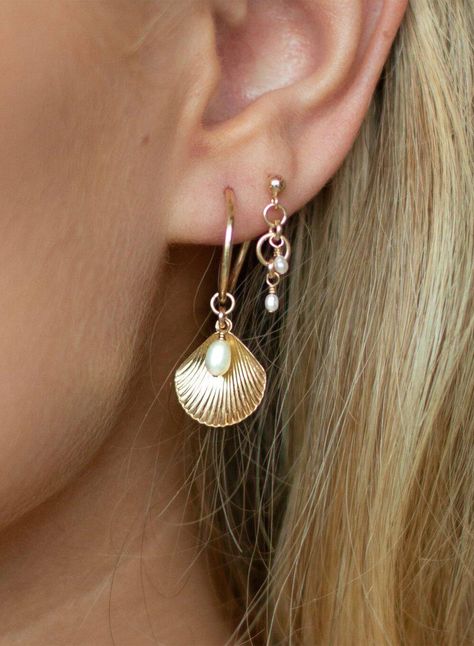 ALANA MARIA JEWELLERY - This enchanting piece will become a favourite in your collection. Captivating upon first glance these earrings feature a charming shell pendant accompanied by a Freshwater Pearl details and delicately hung from a 14k gold-filled Hoop. Adorn yourself with the beautiful Ula Shell Hoop earrings, pair alone or in a stack to achieve a beautifully curated ear. - Sold as a pair- Hoop earring- Shell pendant feature-Freshwater Pearl detail- 14k gold-filled Hoop measurement: 15mm Please note, due to hygienic purposes we do not refund or exchange any Alana Maria Jewellery earrings Alana Maria Earrings, Infinite Jewelry, Alana Maria, Gold And Pearl Earrings, Shell Accessories, Shell Hoop Earrings, Curated Ear, Surf Jewelry, Christian Bracelets