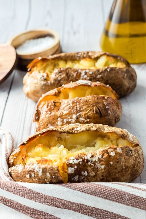 Crispy, oven-baked potatoes are a restaurant-inspired favorite! This method of salt baked potatoes results in crispy outside with fluffy, buttery insides. You only need a few ingredients to make this delicious side dish. Learn expert tips on how to get that crispy skin that rivals your favorite steakhouse. Crispy Jacket Potato, Salt Baked Potatoes, Salted Baked Potato, Weekly Dinner Recipes, Baked Potatoes In The Oven, Cheap Side Dishes, Oven Roasted Veggies, Cooking Baked Potatoes, Buttery Potatoes