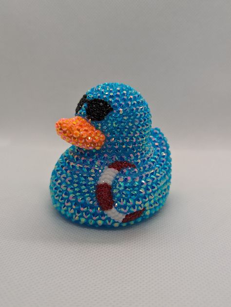 Summertime rhinestone rubber duck. A perfect gift for yourself or your favorite off-road enthusiast! Each rhinestone is hand-placed. Duck is approximately 2.75 in. x 2.75 in. You may notice an odor coming from the duck. It is from the extra-strength glue used to place the rhinestones. Leave the duck in a well-ventilated area, and the smell will dissipate in a few days. *If you plan to keep the duck in a vehicle, keep an eye on it when it is hot outside. Rubber ducks are known to melt or misshapen in hot temperatures. NOT A TOY. CONTAINS SMALL PARTS. NOT INTENDED FOR CHILDREN. NOT FOR USE IN WATER. Duck Things, Rubber Duckies, Rhinestone Projects, Hot Outside, Bling Crafts, Duck Art, Rubber Ducks, Custom Air Force 1, Pinterest Ideas