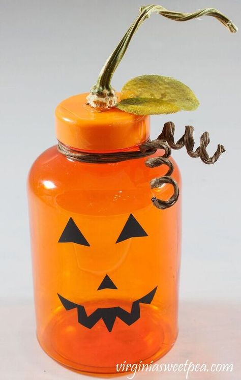 After taking the last calcium supplement in my bottle, instead of recycling the bottle like I usually do, I turned it into an adorable jack-o-lantern to use for Halloween decor. Visit my blog for more DIY, craft, and home decor ideas! Learn How to Create This Adorable Jack-o-LanternI can't get enough of Halloween once the calendar rolls over to October. Let's see how I upcycled a medicine bottle into an adorable jack-o-lantern! Material Used to Make the Upcyled Jack-o-LanternFor th… Pill Bottle Crafts, Halloween Vignette, Block Pumpkins, Pill Bottle, Rag Garland, Medicine Bottle, Faux Leaf, Pill Bottles, Food Candles