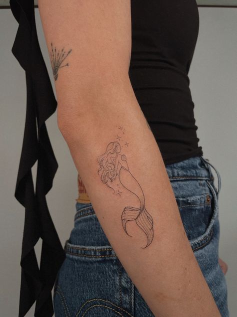 Mermaid Tattoos Aesthetic, Dainty Back Shoulder Tattoos For Women, Minimalist Mermaid Tattoo Simple, Sister Mermaid Tattoos, Unique Fish Tattoo, Mystical Mermaid Tattoo, Tiny Mermaid Tattoo Simple, Seahorse Flower Tattoo, Live In The Moment Tattoo Symbol