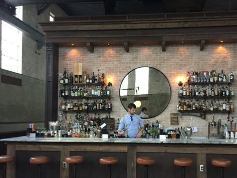 Round mirror behind bar Mirror Behind Bar, Mirror Shelves, Basement Wet Bar, Mirror Bar, Brewery Bar, Restaurant Design Inspiration, Palm House, Bar Mirror, Back Bar