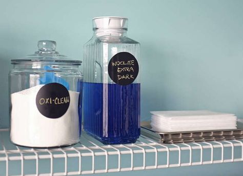 Keep laundry room necessities in clear containers to streamline your washing routine—and rid the room of bulky items. Learn more “zero dollar” ways to organize your laundry room. Laundry Detergent Storage, Laundry Soap Dispenser, Laundry Room Folding Table, Detergent Storage, Laundry Room Hacks, Vintage Laundry Room, Room Storage Diy, Pretty Storage, Laundry Room Inspiration