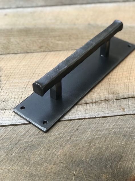 "This is an extra heavy , durable door pull. Ideal for barn doors or rustic decor. Hand hammered steel handle and back plate. Made 100% by hand in our small Vermont blacksmith shop. The mounting backplate on this handle measures 3\" wide, making it ideal for covering holes or imperfections in repurposed doors Intended for indoor use. Four 1-4\" holes are predrilled. Comes with 1\" square head screws for mounting. Back plate is 12\" long, 3\"wide and 1/4\" thick. Handle is 10\" long and made with Repurposed Doors, Industrial Barn Door, Exterior Sliding Barn Doors, Making Barn Doors, Barn Door Latch, Barn Door Handle, Closet Door Handles, Barn Door Hinges, Horse Barn Designs