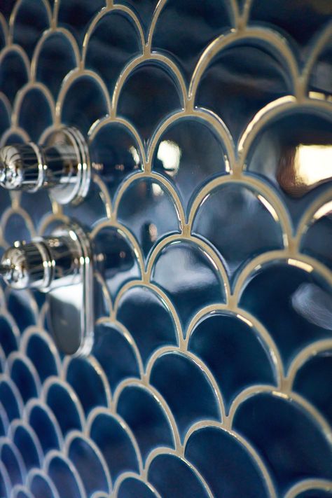 A close-up of a shower wall featuring glossy navy scallop tiles that reflect light beautifully, creating a rich, luxurious effect. Two chrome shower controls are mounted on the tiles, adding a modern contrast to the deep blue hues. The intricate scallop pattern and polished chrome accents enhance the elegance and sophistication of the bathroom design. Navy Shower Tile, Scallop Tile, Navy Blue Tile, Scallop Tiles, Shaker Vanity, Timber Vanity, Eclectic Bathroom, Luxury Family, Bathroom Installation