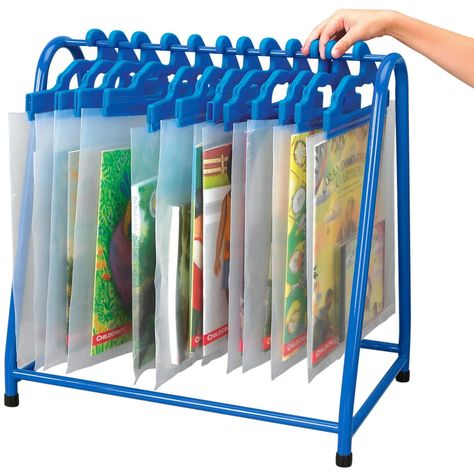 Chaos and clutter are no match for this hanging bookshelf solution. This read-along rack is designed to organize your physical storytime media so you know exactly where to find it. No matter how hectic storytime or playtime gets, rest easy knowing each book and CD has a home in this bookrack. Easily pick up right where you left off with this thoughtfully designed literacy stand. This book stand can hold up to 30 read-along book-and-tape or CD sets in literacy bags. Bags sold separately. Non-slip rubber-tipped feet prevent this rack from sliding or damaging floors. Easy assembly. Hardware and instructions included. Available in blue. Product Brochure Literacy Bags, Metal Storage Rack, Hanging Bookshelves, Welcome To School, Metal Storage Racks, Book Rack, Home Daycare, Metal Rack, Childcare Center