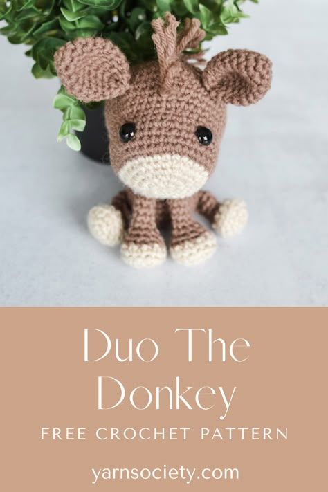 A brown crocheted donkey sitting next to a green plant. Free Donkey Crochet Pattern, Free Crochet Donkey Patterns, Mini Horse Crochet Pattern Free, Donkey Amigurumi Free Pattern, Goat Amigurumi Free Pattern, Amigurumi Horse Free Pattern, Free Horse Crochet Pattern, Crochet Donkey Free Pattern, Donkey Crochet Pattern Free