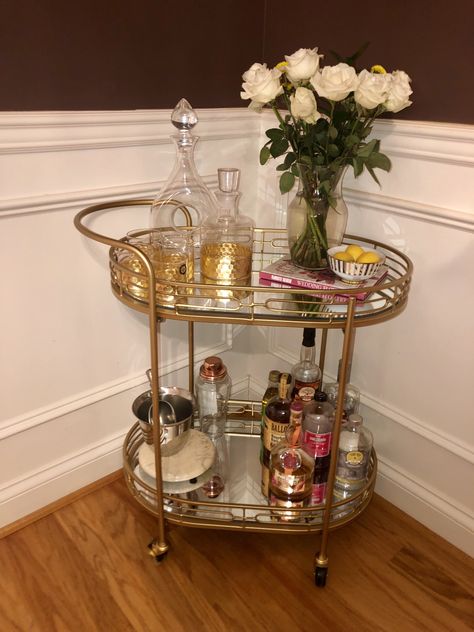 Basic bar cart styling! Still have some tweaking to do. Decanters and other bar ware, ice bucket and shaker, liqueurs and mixes, a bowl of fruit, small coffee table book and a vase of flowers for height. Vintage Bar Cart Styling, Small Bar Cart, Kitchen Appliance Garage, A Bowl Of Fruit, Bowl Of Fruit, A Vase Of Flowers, Home Cocktail Bar, Drink Cart, Vintage Bar Carts