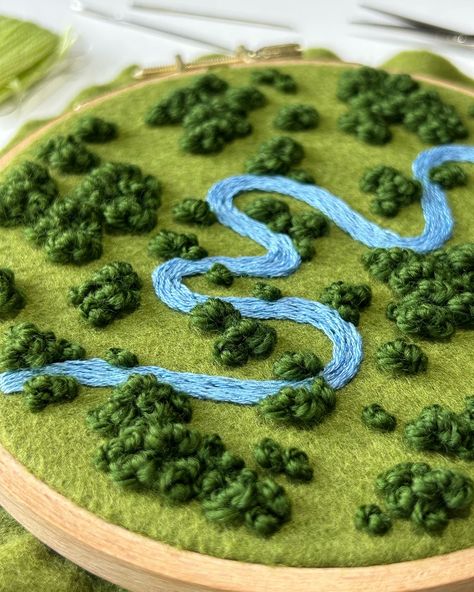 Progress on this floral river landscape ✨ Do you like this crazy winding river? Let me know! I found some aerial photos with twisting and turning rivers, and I really wanted to include all that movement into a piece. This is a 5 inch hoop with lots of movement and texture so far. I can’t wait to add the flowers! . . . @dmc_embroidery @dmc_crafts #embroidery #embroidered #needlework #handembroidery #fiberart #fibreart #textileart #dmc #threads #dmcthreads #embroideryartist #embroideryart #... Aerial Landscape Embroidery, Embroidered Scenery, Aerial Embroidery, River Embroidery, Weather Embroidery, Grass Embroidery, Rock Embroidery, Moss Embroidery, Embroidery Map