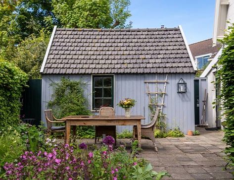 Learn how to refresh the paint on a wood or metal shed with a step-by-step guide from the experts at Benjamin Moore, including helpful tips and project duration. Long Wooden Dining Table, Painting Shed, Pitcher With Flowers, Prefabricated Sheds, Brick Shed, Blue Shed, Vinyl Sheds, Prefab Sheds, Build A Shed