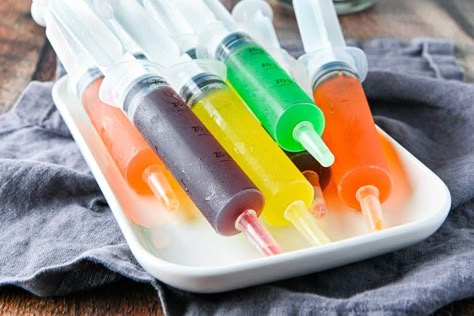 Looking for an outrageous party treat? Learn how to make multi colored syringe jello shots with just a few simple ingredients. Perfect for any bash, these are sure to wow your guests! Jello Syringe Shots, Superbowl Party Decorations Diy, Jello Shot Syringes Recipe, Berry Yogurt Bowl, Vodka Gimlet Recipe, Nurse Grad Party, Vodka Gimlet, Gimlet Recipe, How To Make Jello