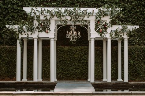 This Charleston Wedding at William Aiken House was Filled with Italian Flair  William Aiken House ceremony pergola with greenery   Planning and Design @acharlestonbride Photography @seanmoneyelizabethfay Pergola With Greenery, Italian Pergola, Italian Backdrop, Ceremony Pergola, Bridgerton Theme, Arches Wedding, Traditional Wedding Favours, Wedding Drapery, Modern Wedding Theme