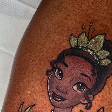 ✨Amanda Graves✨ 𝑔𝓁𝒾𝓉𝓉𝑒𝓇 𝓉𝒶𝓉𝓉𝑜𝑜𝓈 on Instagram: "Sparkly Princess Tiana (my favorite one hehe) #glittertattoo #princesstiana" Princess Tiana Tattoo Ideas, Princess Tiana Tattoo, Tiana Tattoo, Princess And The Frog Tattoo, Tiana And Naveen, Disney Sleeve, Sweet 16 Themes, Frog Tattoos, Birthday Dinner Party