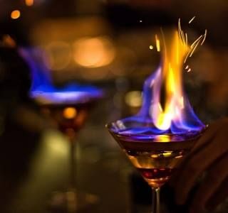 Drink of the day  Flaming Lambourgini  Ingredients: 1.667 oz Blue Curacao 1.667 oz Coffee Liqueur 1.667 oz Galliano 1.667 oz Milk 1 oz Sambuca  Instructions: Pour one ounce shot of Buca into Martini glass. Using four single jiggers, put two on each side of Martini glass. Pour other ingredients in these jiggers. Ignite the Sambuca and sprinkle some CINNAMON on top of the flame. Pour the Blue Curacao and Galian Flaming Cocktails, Sambuca Drinks, Flaming Dr Pepper, Ice Party, Whisky Sour, Fire Image, Water Wedding, Unicorn Foods, Blue Flame