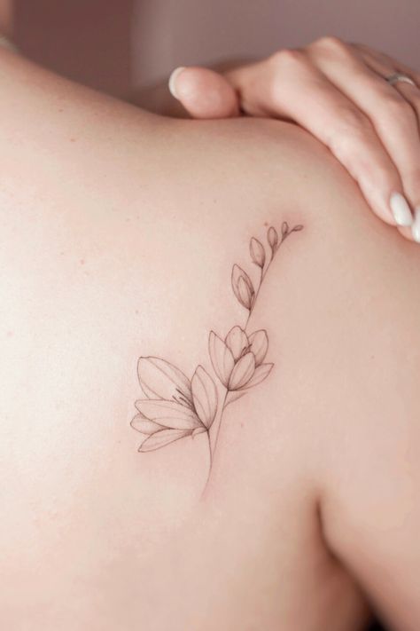 Best Magnolia Tattoos: Ideas, Designs, and Meanings Dainty Magnolia Tattoo, Japanese Magnolia Tattoo, Magnolia Tattoo Fine Line, Magnolia Branch Tattoo, Magnolia Tattoo Simple, Magnolia Tree Tattoo, Small Magnolia Tattoo, Magnolia Tattoo Design, Magnolia Flower Tattoo