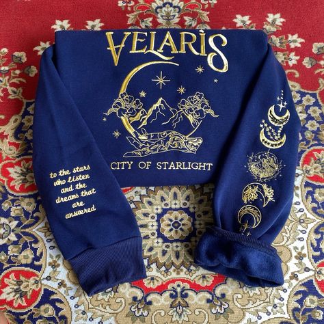 Immerse yourself in the world of Acotar with this stunning “Velaris City of Starlight” embroidered navy sweatshirt! ✨ Exquisitely detailed with unique designs, it perfectly blends fashion with your love for the “A Court of Thorns and Roses” series. What could be better than wearing a piece of art and stepping into your dreams? 🌙📚 #bookstagram #acotar #velariscityofstarlight #velaris Bat Boys, Star City, Embroidered Hoodie, Bookish Gifts, Embroidered Sweatshirts, Embroidered Shirt, Book Lovers Gifts, Book Lovers, Sweat Shirt