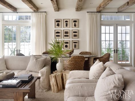 The combination living-and-dining room showcases designer Melanie Turner’s deft use of tactile textures to create a serene space. The linen-slipcovered sofas are by Lee Industries, and the coffee table is from South of Market. Apartment Ceiling, Remodel Entryway, Melanie Turner Interiors, Decoration Pictures, Interior Livingroom, Interior Colors, Decor Videos, Coastal Living Rooms, Decor Elements