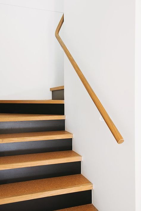 Even the stairs reflect the materials at the heart of the project with their blend of cork, timber, and black against a white backdrop. An Australian Renovation Gives New Life to Midcentury Style - Photo 10 of 15 Cork Staircase, Mcm Stairs, Cork Stairs, Wooden Stairs Ideas, Painting Wooden Stairs, Stairways Ideas, Australian Renovation, Black Handrail, Stairs Painted