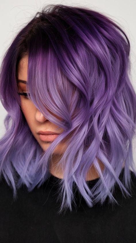 Discover the enchanting world of pastel hair with this stunning lavender and purple balayage! The soft waves and rich color blend create a playful yet sophisticated look. Perfect for those looking to add a touch of whimsy to their style while maintaining an air of elegance. Balayage Purple Hair Blonde, Peakaboo Underlights Lavender, Ash Blonde And Purple Hair, Black And Purple Halo Hair, Purple And Lilac Hair, Purple Hair Shadow Root, Unique Purple Hair, Purple Hair Ideas For Brunettes, Lavender And Black Hair