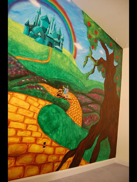 Wizard of oz themed mural by caras creations for a child's nursery. Look at the other examples of my children murals! Contact me if interested. I use acrylic paint on walls to create murals Wizard Of Oz Wall Murals, Wizard Of Oz Mural, Wizard Of Oz Canvas Painting, Wizard Of Oz Nursery Theme, Book Mural, Library Mural, Wizard Of Oz Play, Bedroom Theme, Classroom Idea