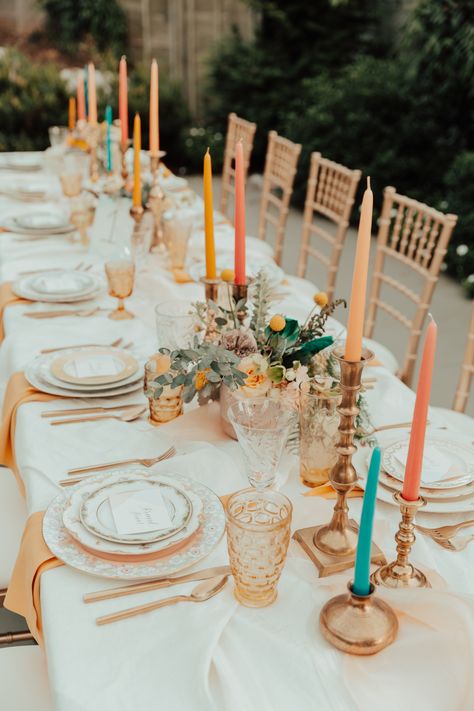 There are so many good things about this playful head tablescape, we are hardly know where to begin! From the layered linens where the vibrant teal peaks through, to the multicolored candles in our vintage brass candlesticks, to the hand-lettered and dip-dyed place cards - there are so many good details that work together to create this striking tablescape. #Chattanooga #wedding #colorfulwedding #weddingdecor #tablescape Taper Candle Centerpiece, Candle Tablescapes, Candlestick Centerpiece Wedding, Boho Reception, Taper Candles Wedding, Backyard Boho, Colored Taper Candles, Yummi Candles, Wedding Candles Table