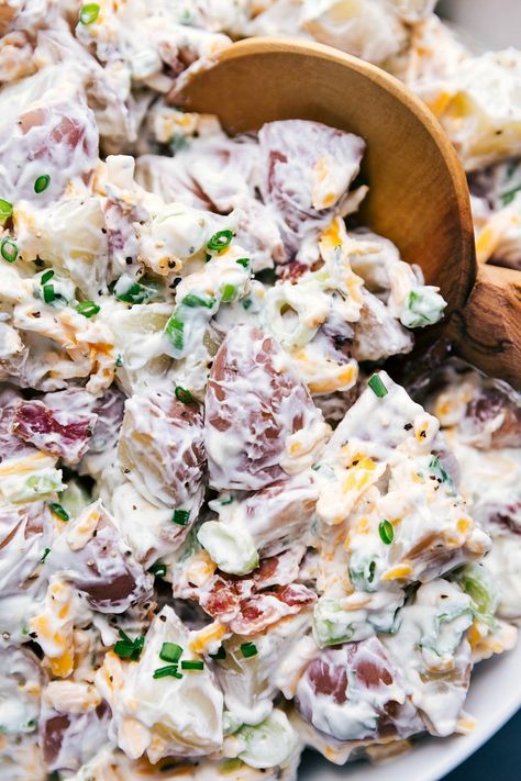 This Ranch Potato Salad is loaded with tender red potatoes, sharp Cheddar cheese, crispy bacon, and fresh green onions. This salad has a quick two-ingredient ranch and sour cream dressing. Recipe via chelseasmessyapron #bacon #recipe #cheddarbacon #easybacon #easy #creamy #ranch #potato #salad Sour Cream Potato Salad, Red Potato Salad Recipe, Loaded Potato Salad, Sour Cream Potatoes, Ranch Potato Salad, Roasted Potato Salads, Bacon Ranch Potatoes, Potato Salad Recipe Easy, Red Potato Salad