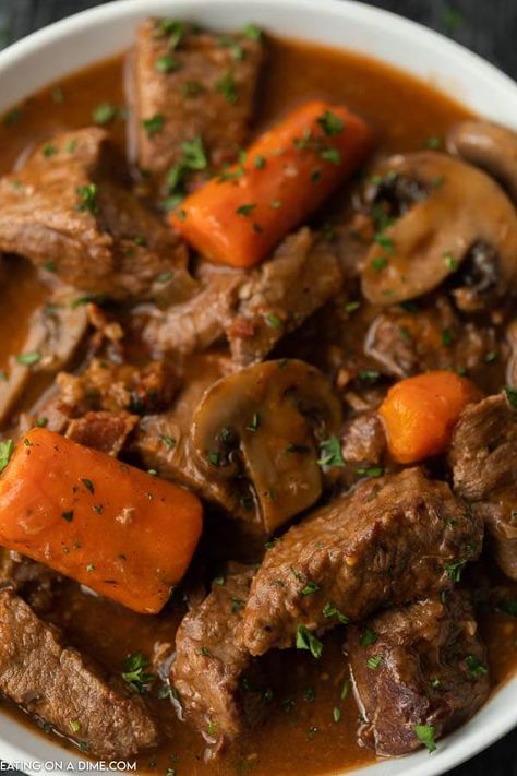 Slow cooker beef bourguignon sounds fancy and tastes amazing but the recipe is so easy to make. The beef is tender and the broth is savory. Beef Burgonione, Slow Cooker Beef Bourguignon, Beef Stew Meat Recipes, Beef Bourguignon Recipe, Beef Crockpot, Eating On A Dime, Stew Meat Recipes, Stew Chicken Recipe, Beef Roast