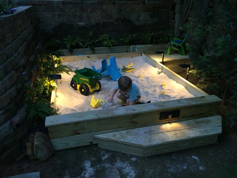 Custom sandbox, with storage and mini-deck, LED lighting. Requires 44 50lb bags of sand. Sandbox portion is 6' x 8'... Built in 2 days on the weekend. Built In Sandbox Sand Pit, Outdoor Sandbox Ideas Easy Diy, In Ground Sandbox Ideas, Big Sandbox Ideas, Sand Box With Lid, Sandbox Toy Storage Ideas, Large Sandbox Ideas, Outdoor Sandbox Ideas, Sandbox Storage