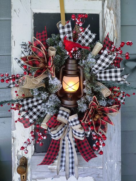 NOTICE: lanterns are on back order and will not be available until the end of September.  Farmhouse Christmas Lantern Wreath, Rustic Christmas Wreath, Front Door Wreath, Farmhouse Decor, Christmas Farmhouse, Buffalo Check Wreath, Made on a 24" flocked pine, this one will light up your space with a Rustic flame glow lantern with a mix of greenery and frosted berries, burlap deco mesh, and adorned with  Farmhouse  buffalo check ribbon and bow. Greenery May differ depending on supplies This one mea Country Rustic Christmas, Christmas Decorating Hacks, Lantern Wreath, Farmhouse Decor Christmas, Amazing Christmas Trees, Fall Decor Wreaths, Floral Door Wreaths, Rustic Christmas Wreath, Buffalo Check Christmas