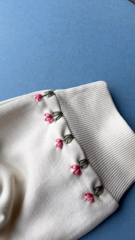 Spring Blooms 🌷 . . #sustainableclothing #handmadestyle #embroideryinstaguild #dmcembroidery #sewing #embroideryart #embroideryhoop… | Instagram Patterns For Embroidery Ideas, Beginner Embroidery On Clothes, Simple Embroidery Beginner, Trendy Hand Embroidery Designs, Simple Diy Embroidery Designs, Embroidery Inspiration On Clothes, Embroidery Cardigan Diy, Stitched Flowers Embroidery, Cute Sweater Embroidery