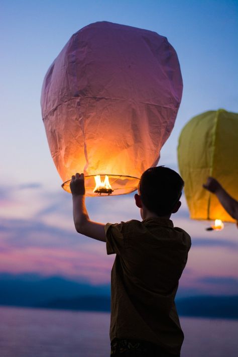 sky-lantern 12. Light a sky lantern with your loved one’s name on it and a message and release it at night.  This could be done for a celebration of life service, or on another special occasion.  If you have lost several family members, you could release a number of lanterns at once.  (Be sure, however, to check if you need a permit to release a sky lantern, and do not release the lantern where it is a potential fire hazard.) Birthday In Heaven, Sky Lanterns, In Memory Of Dad, Memorial Service, Activities To Do, Positive Attitude, Hd Photos, Celebration Of Life, Good News