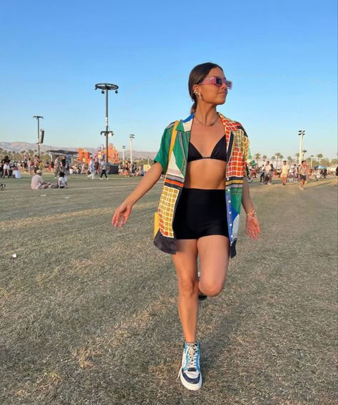 festival woman in black skirt bikini top and oversized shirt Festival Outfit With Converse, Music Festival Outfits Night, Sylvan Esso Concert Outfit, Practical Festival Outfit, Wonderfront Festival Outfits, Comfy Festival Outfit Summer, Truck Festival Outfit, Sporty Festival Outfit, Tomboy Festival Outfit