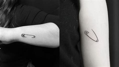 What Does An Open Safety Pin Tattoo Mean at Joannehinman Check more at https://ideatatto.com/meaning/what-does-an-open-safety-pin-tattoo-mean-at-joannehinman/ Safety Pin Tattoo, Pin Tattoo, Small Wave Tattoo, Tattoos Aesthetic, Tattoo Couple, Tattoo Symbols, Drawing Pin, Wave Tattoo, Tattoos For Black Skin