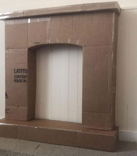 This DIY cardboard fireplace idea is really thinking outside the box! Diy Cardboard Fireplace, Faux Fireplace Diy Cardboard, Fake Fireplace Diy, Real Fireplace, Diy Christmas Fireplace, Cardboard Fireplace, Decorative Fireplace, Fake Fireplace, Fireplace Diy