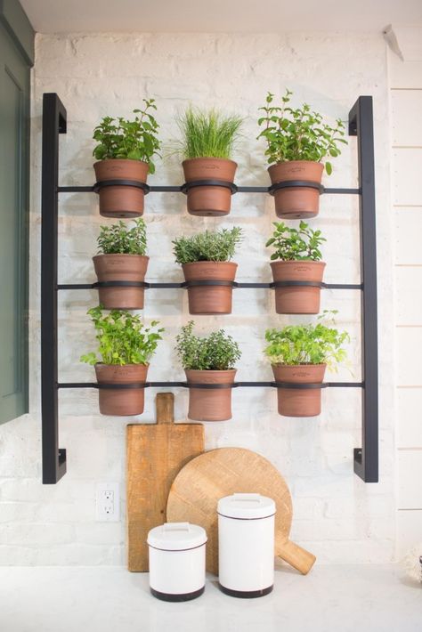 I designed this wall planter that my welder Cody built and installed these terracotta pots that Black Oak Art custom made. This was definitely one of my favorite elements in this entire home and really personalized the space for the Messeralls. Stile Joanna Gaines, Magnolia Fixer Upper, Hanging Herb Garden, Herb Wall, Hanging Herbs, Herb Garden In Kitchen, Balkon Design, Herb Garden Design, Kitchen Herbs