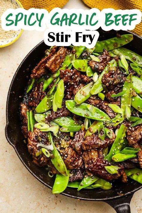 Spicy Garlic Beef Stir Fry is a great busy weeknight dinner! Flank steak, onions, and snow peas in a stir fry sauce full of garlicky, spicy, and sweet flavor. Easy Mongolian Beef is a quick beef stir fry dinner that readers love to make when they want Asian Food fast. Beef And Pea Pods Stir Fry, Beef And Snow Pea Stir Fry, Garlic Beef Stir Fry, Beef And Snow Peas, Thai Beef Stir Fry, Spicy Beef Stir Fry, Spicy Stir Fry Sauce, Stir Fry Dinner, Steak And Green Beans