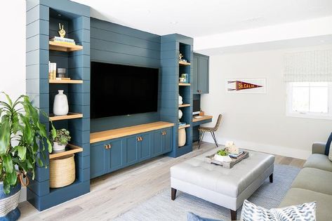 A flat panel television is mounted to a blue shiplap wall between wood floating shelves and over a wood countertop accenting blue shaker cabinets adorned with leather tab pulls. Tv Built In, Built In Entertainment Center, Living Room Built Ins, Coastal Contemporary, Living Room Entertainment, Rack Tv, Transitional Living, Tv Wall Unit, Transitional Living Rooms