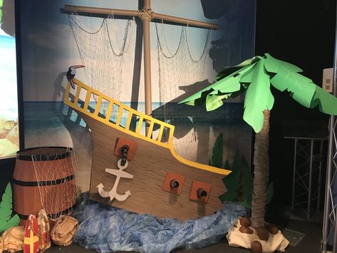 Shipwrecked VBS 2018 stage decorations - my palm tree from a carpet tube, umbrella and corobuff paper, ship made of foam board and a diy barrel from a cardboard box. Pirates Decorations Diy, Diy Shipwreck Decor, Scuba Vbs Stage Decorations, Cardboard Shipwreck, Peter Pan Diy Decorations, Pirate Theme Vbs, Shipwreck Vbs Decorations, Shipwreck Diy, Diy Shipwreck