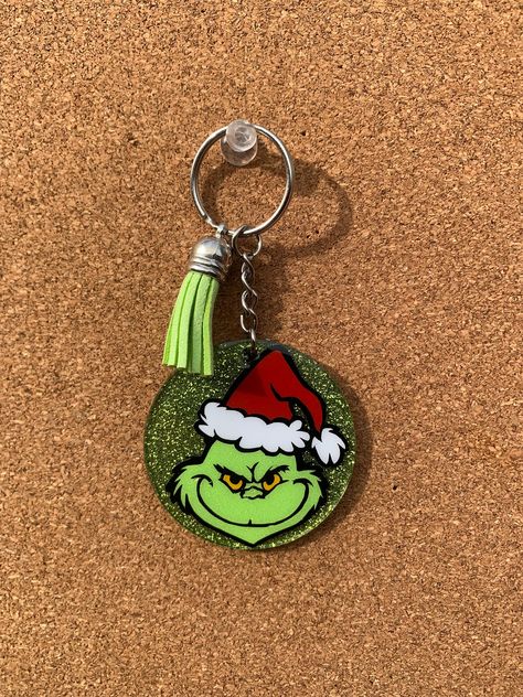 GRINCH KEYCHAIN! The keychain is a green, glittered acrylic keychain that is 2 inches in size. It represents the iconic Christmas character ... Mr. Grinch! Handle & Care info: - Acrylic can break if dropped or hit on hard surfaces - Avoid excessive temperature - Wipe with soft cloth to clean item NO REFUNDS OR EXCHANGES Grinch Keychain, Christmas Craft Fair Ideas To Sell, Preppy Grinch, Craft Fair Ideas To Sell, Grinch Ideas, Diy Grinch, Christmas Keychains, Grinch Stuff, Grinch Crafts