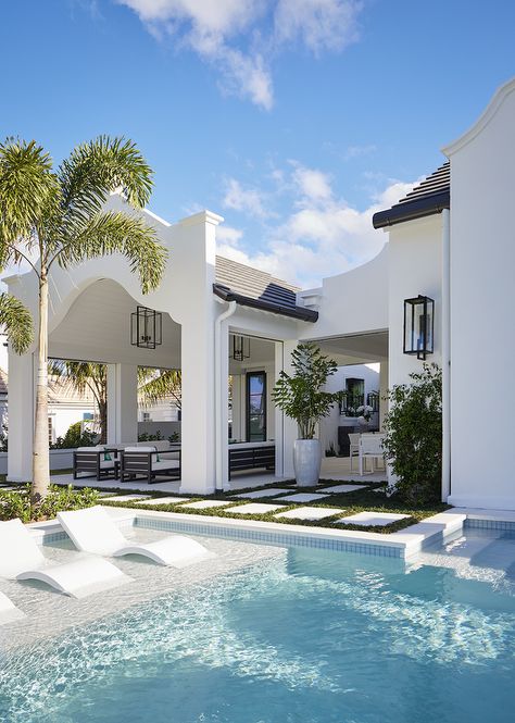 Three modern white pool loungers line a Baja pool ledge. Florida Mediterranean House, Coastal Modern Architecture, Coastal Modern Beach House, Beach House Design Exterior Coastal Homes, Modern Florida Beach House, Palm Beach Exterior Home, Coastal Florida Home, Spanish Modern Pool, Mediterranean Coastal Style