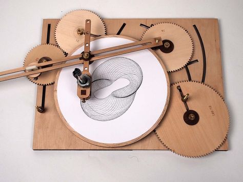 The Cycloid Drawing Machine by Joe Freedman is a device similar to a Spirograph toy made using adjustable and interchangeable wooden gears that can be used to create elaborate and beautiful designs… Wooden Gears, Drawing Machine, Drawing Toys, 3d Cnc, Geometric Quilt, Colossal Art, Kinetic Art, Elegant Tattoos, Paper Toys