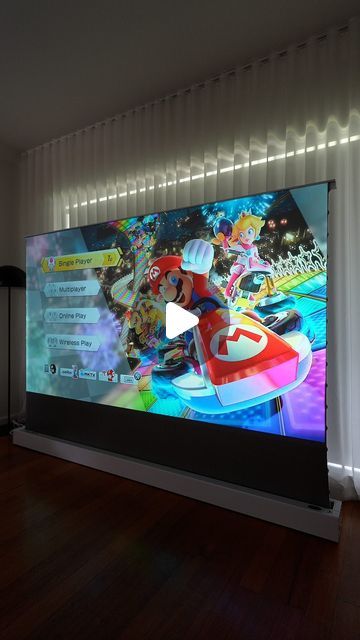 Shannon Grixti on Instagram: "The VIVIDSTORM motorised projector screen is a super immersive 100-inch screen that cleverly pops out of a small box on the floor Comment SCREEN to get a link with product info in your DMs! #vividstorm #projector #projectorscreen #PS5 #PlayStation #TV #hometheatre #Gaming #Gifted" Living Room Projector Wall, Projection Screen, Projector Screen, Future Family, Screen Design, Pop Out, Media Room, Apartment Ideas, On The Floor