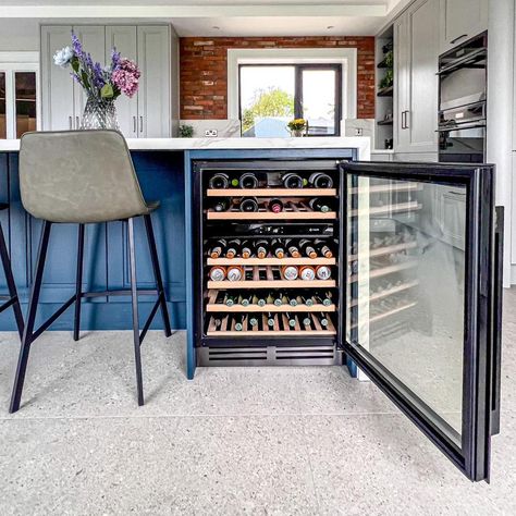 We’re delighted to share these pictures of a #newhavenkitchen - We really love the open shelving - which is so pretty & a feature of the design. The painted bi-folding drinks cupboard really pops - ❗️we can paint your kitchen or feature cupboard whatever colour you wish❗️Featuring the Faber Galileo vented hob - the island is a social space facing into the room. The drinks cooler is near to hand - and 📝we can provide a wide range of wine coolers in different heights, widths or for various loc... Wine Cooler Island, Wine Fridge In Island Bench, Wine Cooler Within Island, Larder Cupboard With Wine Rack, Wine Cupboard, Drinks Cupboard, Undercounter Wine Cooler, Wine Coolers, Social Space