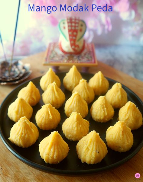 Mango Modak Peda on a black platter with Lord Ganesh Idol in the background. Prasad Recipe, Modak Recipe, Pulp Recipe, Mango Pulp, Ganesh Utsav, Cardamom Powder, Milk Powder, Ganesh Chaturthi, Powdered Milk