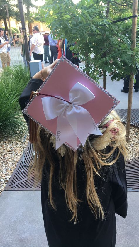 Graduation Cap with bling and bow Bow Cap Graduation, Cap Decoration Ideas College, Cap And Gowns Decoration Ideas, Cheerleader Graduation Cap, Pink Girly Graduation Cap, Grad Cap Sparkle, Cap Decoration Graduation Kindergarten, Fluffy Graduation Cap, K-12 Melanie Martinez Graduation Cap