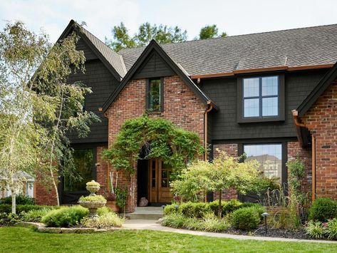 1980s Home Remodel Exterior, Brick House With Dark Siding, Red Brick Dark Siding, Black Siding With Brick, Red Brick Craftsman Exterior, Black Soffit And Fascia Red Brick, Red Brick With Black Siding, Red Brick And Black Exterior, Black And Brick House Exterior