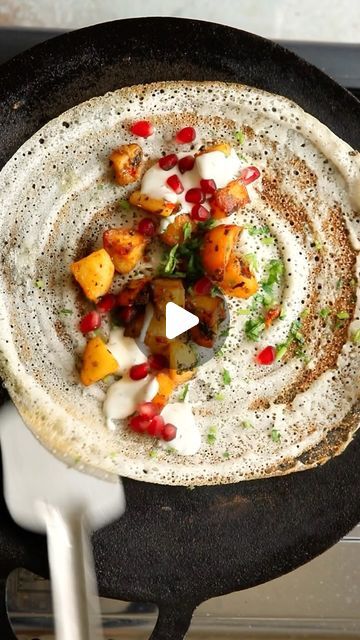 Sanjana Modha on Instagram: "Lebanese-Inspired Batata Harra Dosa. Anti fusion-food police look away now 👀 swirling dosa batter takes me to my happy place.

Indian dosa, lemon and garlic potatoes, red chilli, coriander and pomegranate. Incredible with toum or your favourite chutney. 

Full recipe video link with measurements for making this is in my bio for a short time.

The garlicky-lemony potatoes paired with the crunchy rice and daal dosa is almost like the long-lost sibling of South Indian Masala Dosa.

Who says fusion foods are half-baked ideas? This combination makes so much sense that I can’t believe I’ve never tried it before.

#dosa #batataharra #indianfood #lebanesefood #glutenfreerecipes #potatorecipes" Indian Dosa, Batata Harra, South Indian Dishes, Masala Dosa, Lebanese Food, Garlic Potatoes, Pomegranate Molasses, Spicy Dishes, Lebanese Recipes