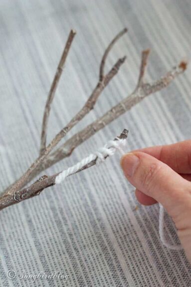 These yarn-wrapped branches are easy to make and can be used to decorate mantels or side tables. These decorative branches are perfect for your winter home decorating. He almost threw them away!Twice! You see I gather stuff. I can go for a walk, just an easy stroll through the neighborhood, an everyday walk so to speak.And come back with my pockets full of finds.Someday finds.Little treasures that have great potential for beautiful creations.I can see it in my mind: the possibilities… Twig Crafts Branches Sticks Diy Ideas, Diy Yarn Decor, Tree Branch Crafts, Knitted Heart Pattern, Decorative Branches, Twig Crafts, Wrapped Sticks, Yarn Trees, Tree Branch Decor