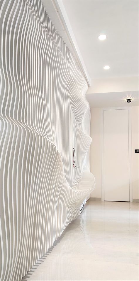 A parametric wave wall with PU paint finish. It seemed impossible to make this with 2 doors hidden in it, but the engineering behind door made it possible. 3d Wall Installation, Parametric Wall Panel, Parametric Wall Design, Waves Architecture, Curved Wall Design, Wave Wall Panel, Parametric Interior, Wavy Wall, Parametric Wall